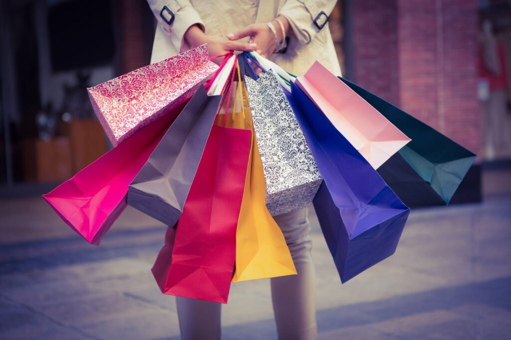 A woman with shopping bags in her hands.