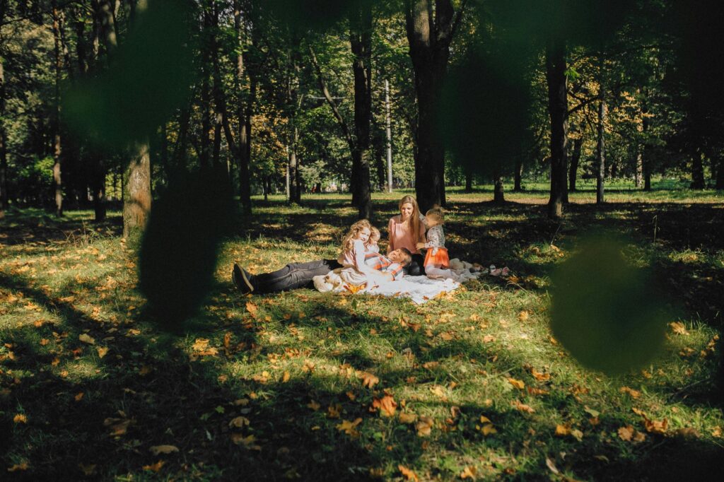 A family is having a picnic in a park on a sunny day