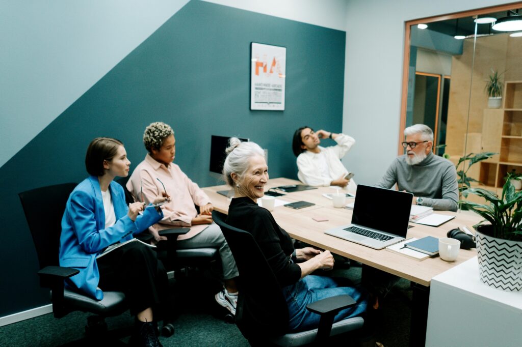 A small group of employees in the meeting room for the office relocation announcement